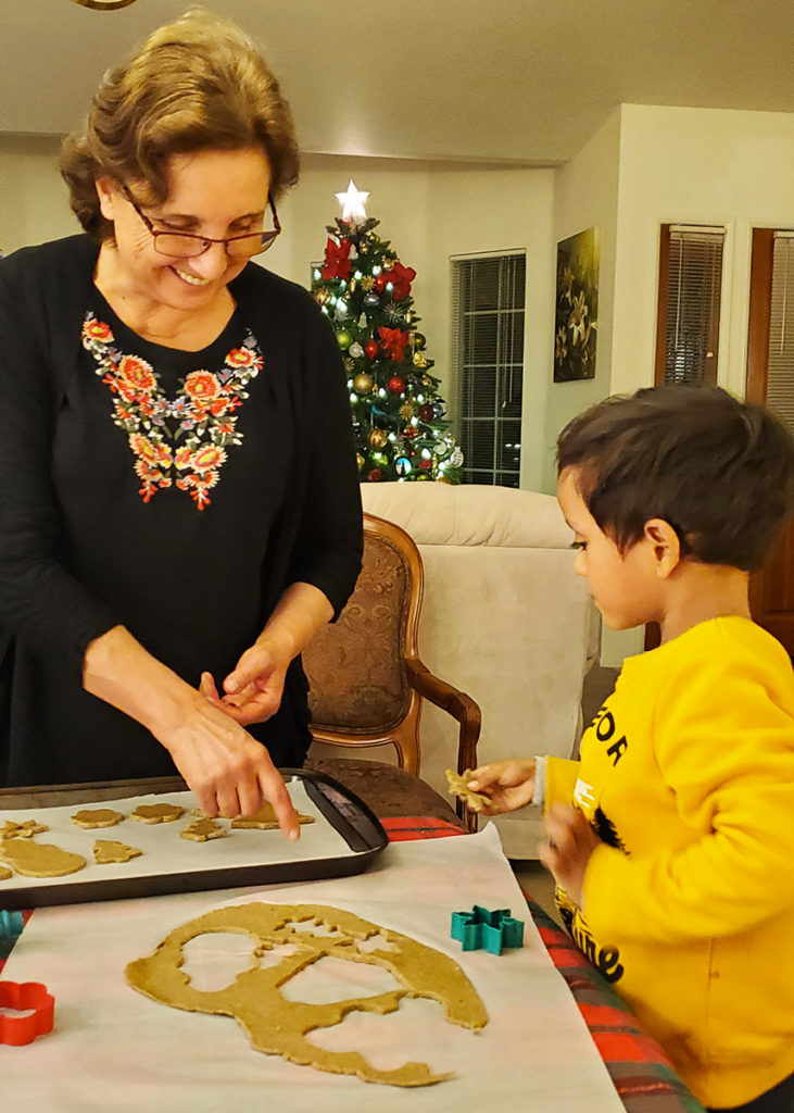 my son and grandma decorating cookies