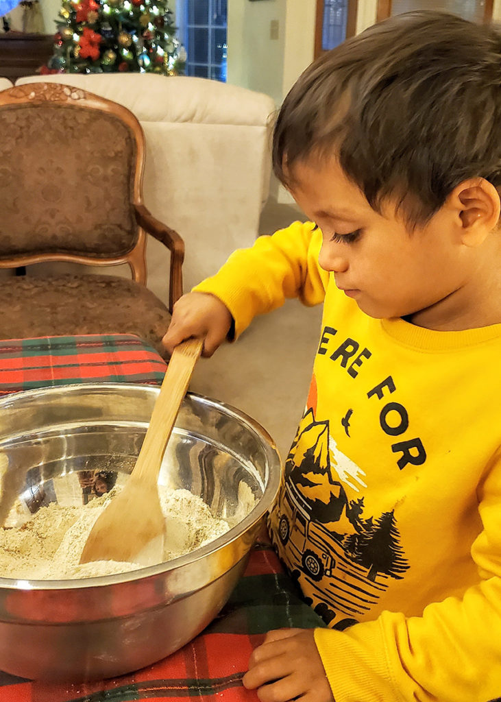 my son mixing dry ingredients for cookies