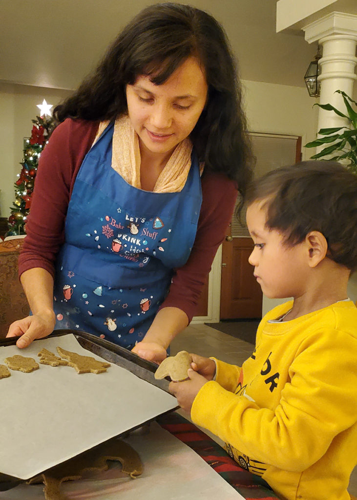 mom and son putting cookies together